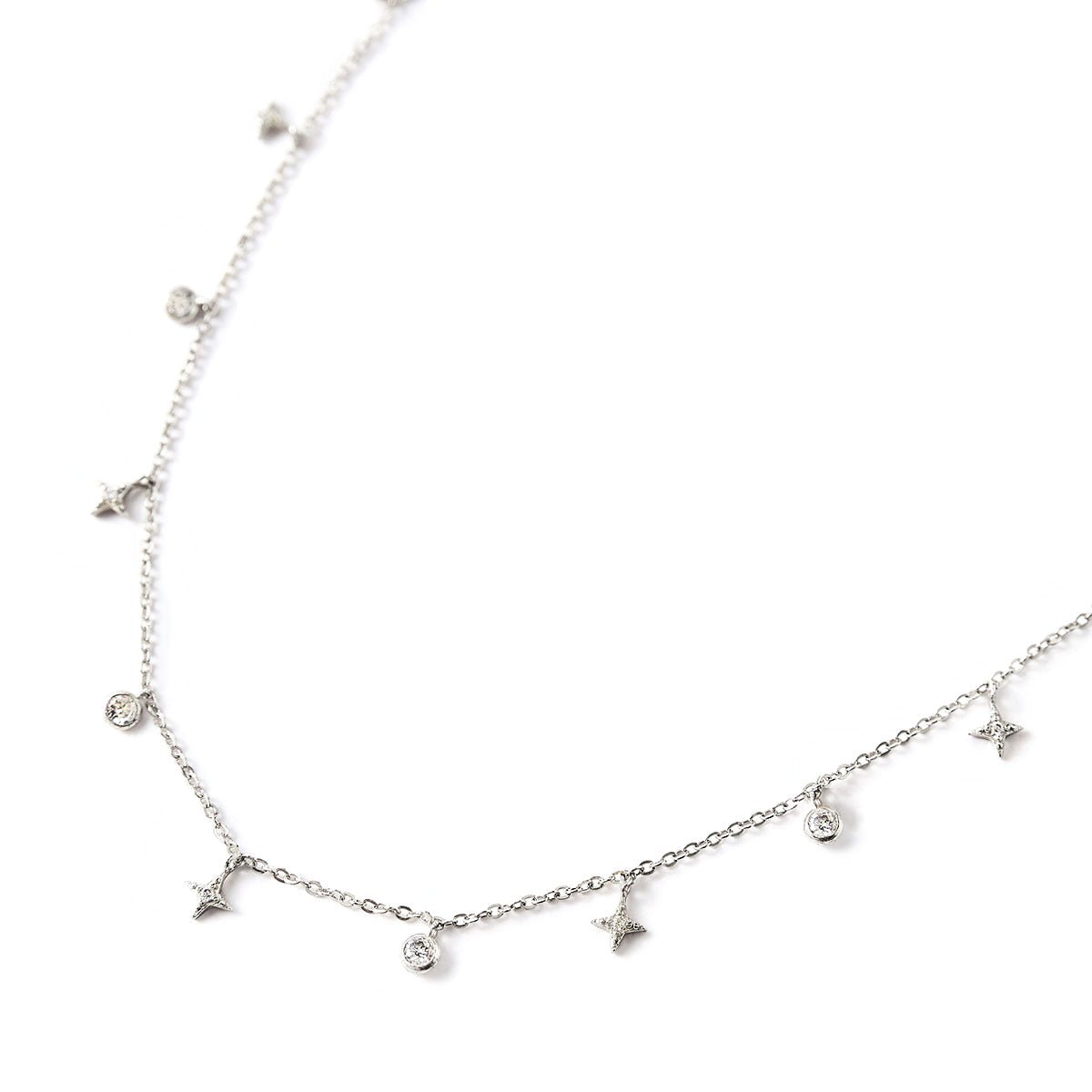 Sterling silver necklace with star charms and round zirconia drops, close-up on a white background