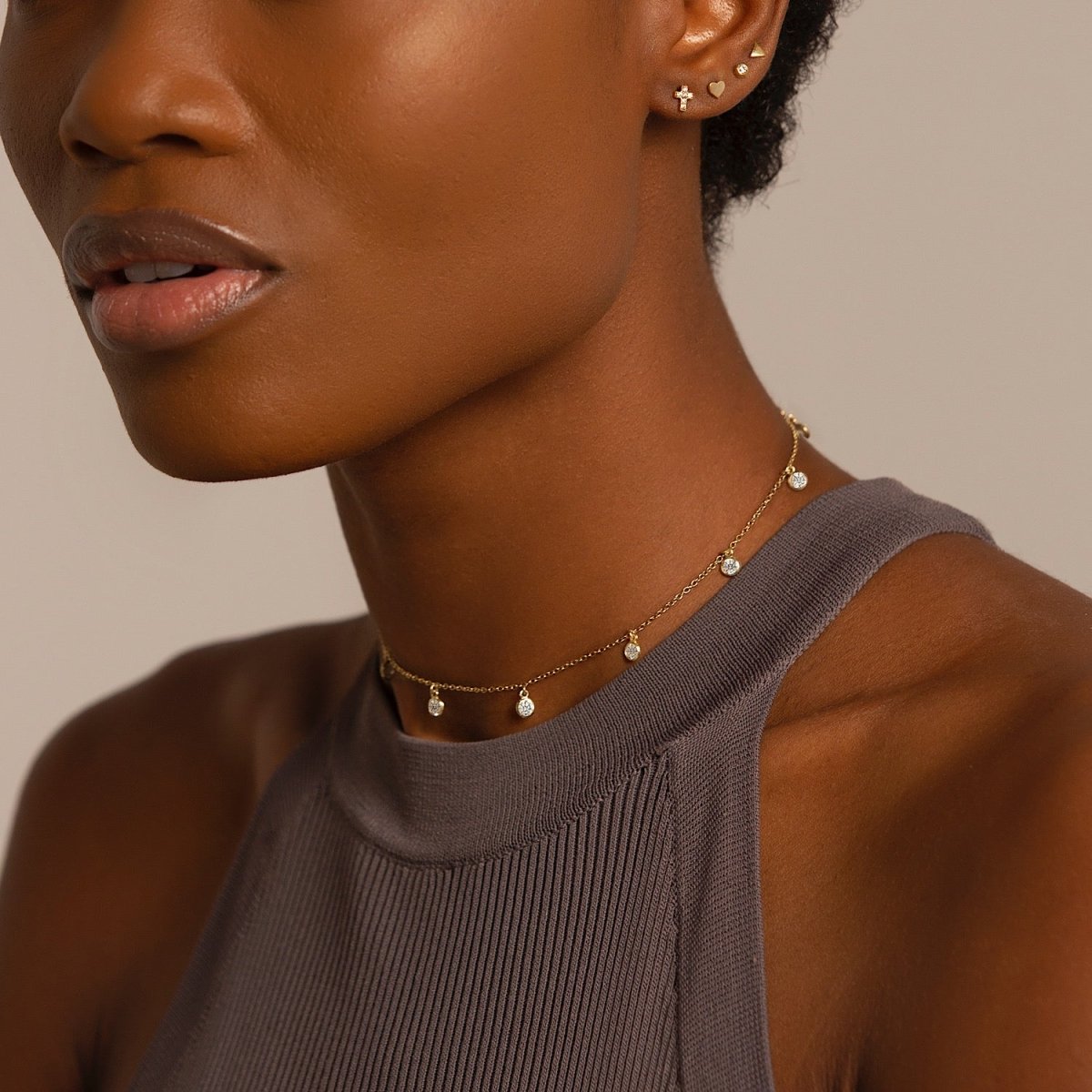 Gold vermeil choker with dangling clear stones, shown on a model's neckline