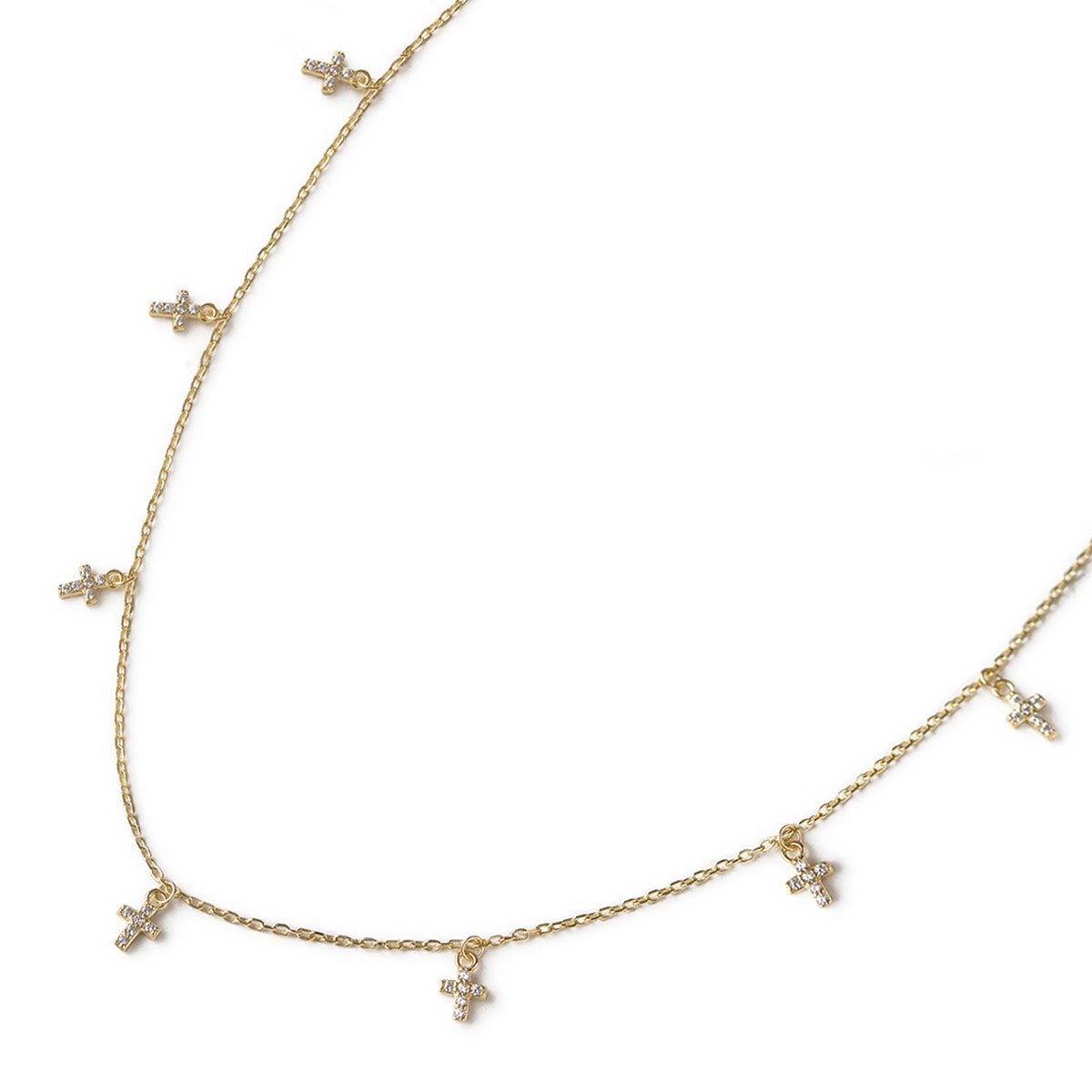 Gold vermeil cross dangle necklace with white zirconia crosses, shown with matching earrings on a white background