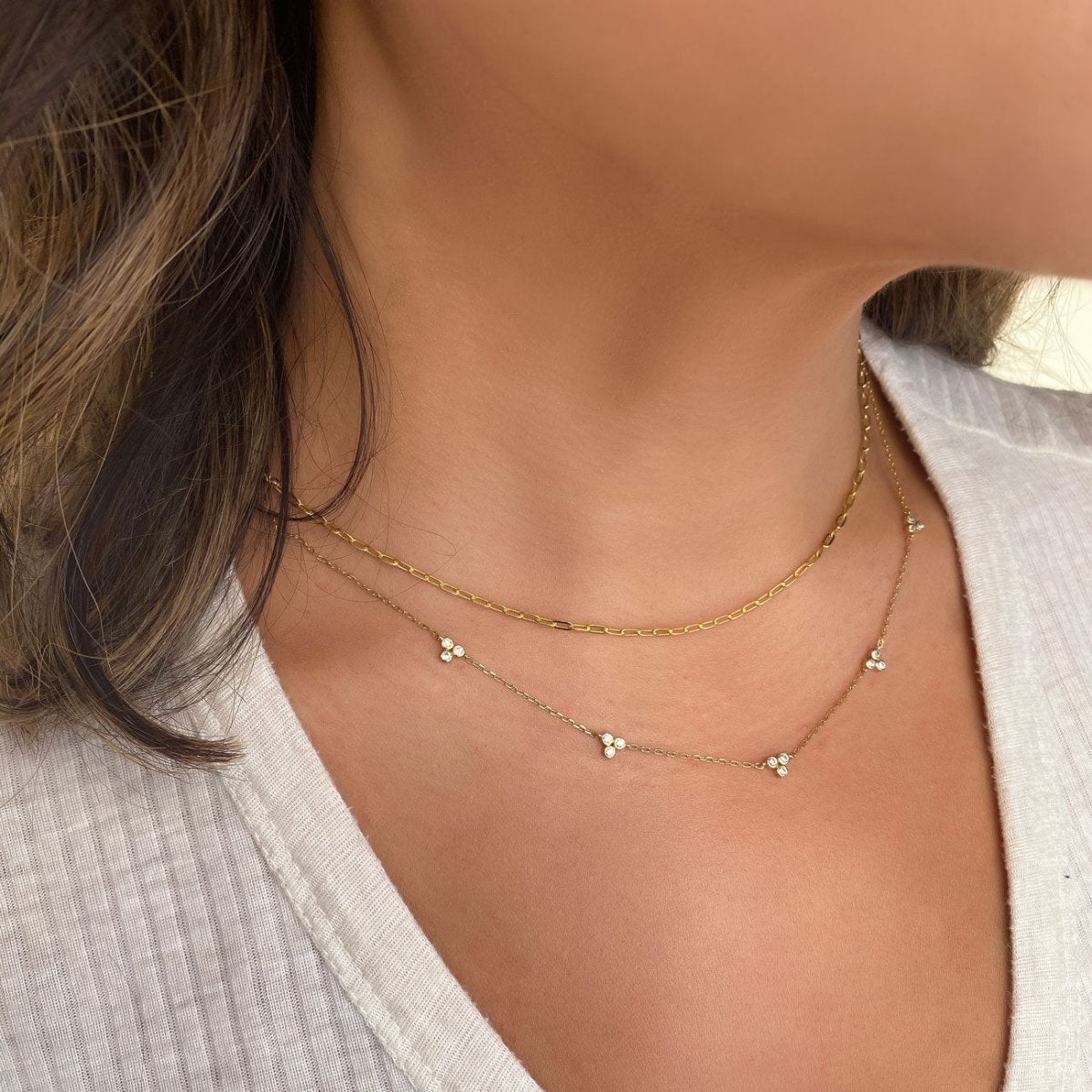 Gold vermeil link chain necklace shown layered on a model's neckline