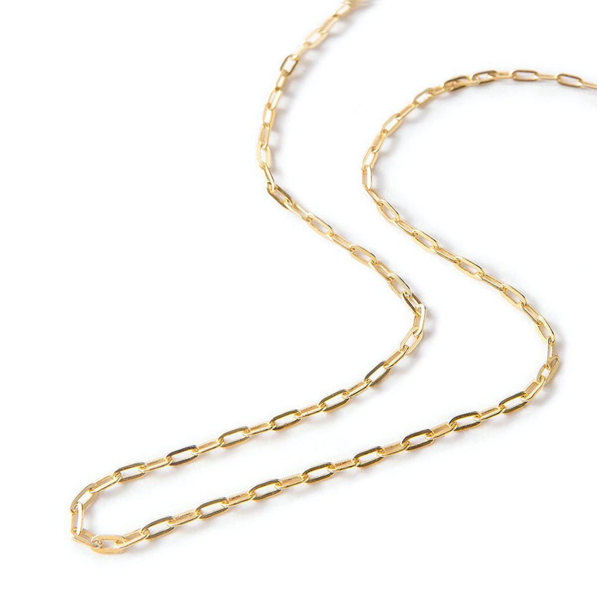 Gold vermeil paperclip link chain necklace coiled on a white background