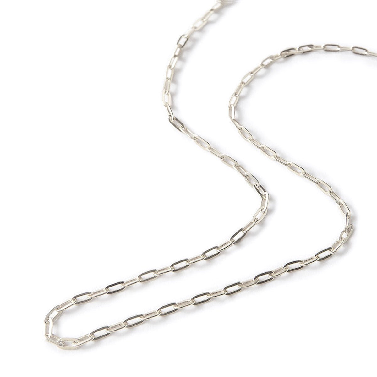 Sterling silver paperclip link chain necklace coiled on a white background