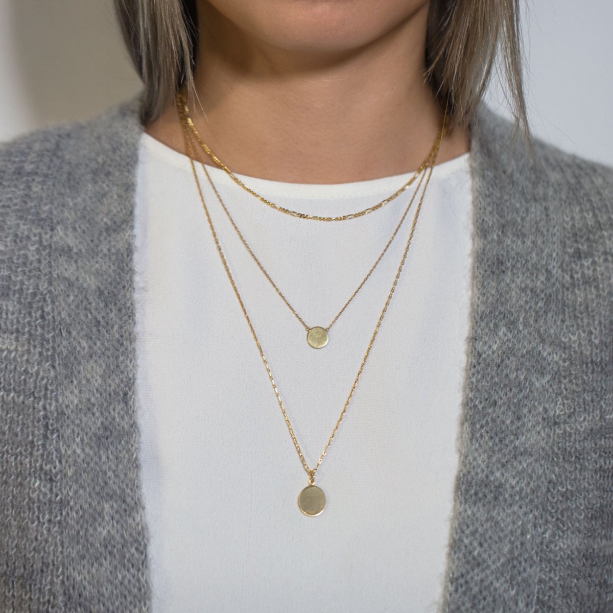 Gold vermeil Figaro disc trio necklace with two layered disc pendants, shown on a model in a cardigan