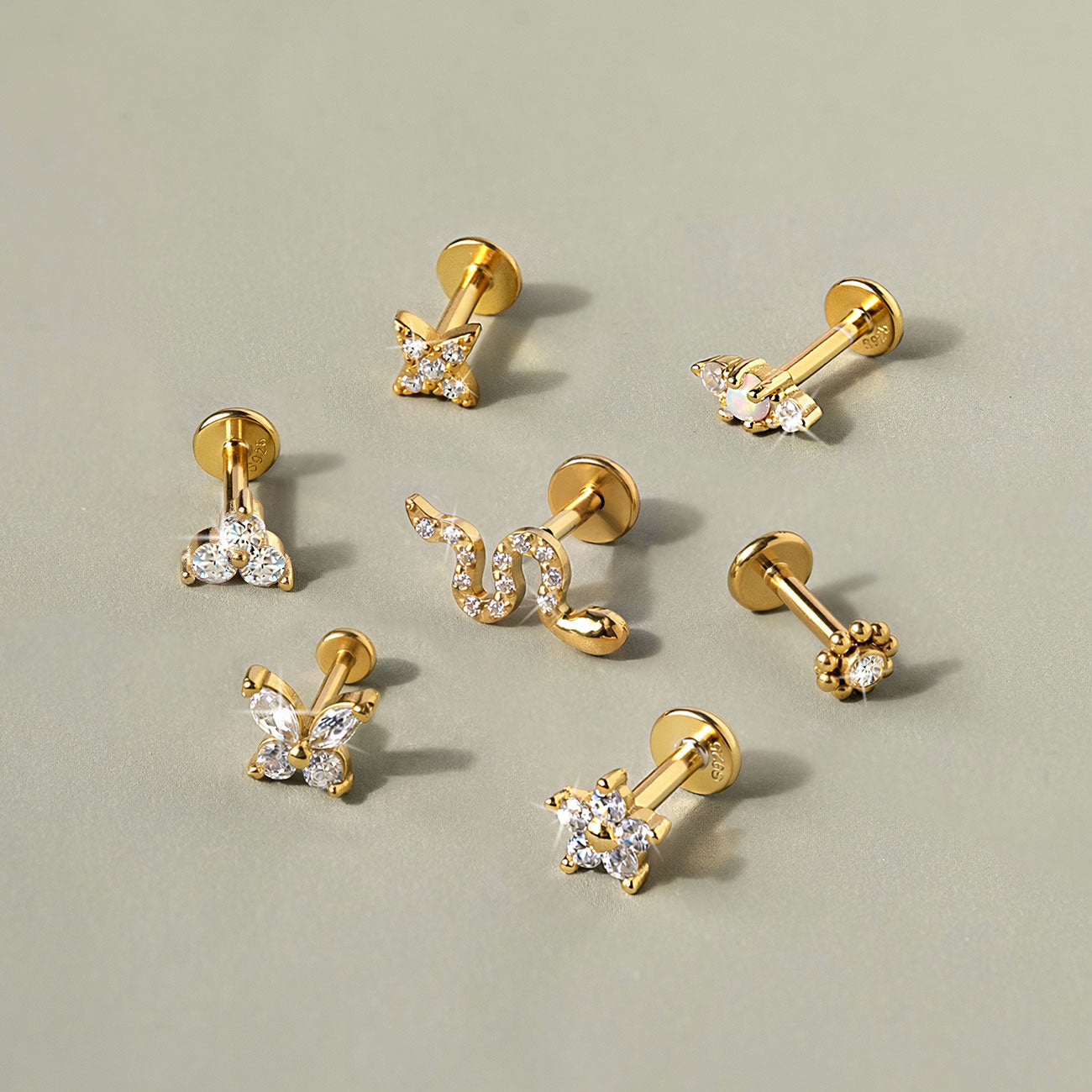 AMYO gold vermeil and gold titanium flat back earrings featuring butterfly, star, snake, flower, and opal stud designs for everyday piercings.