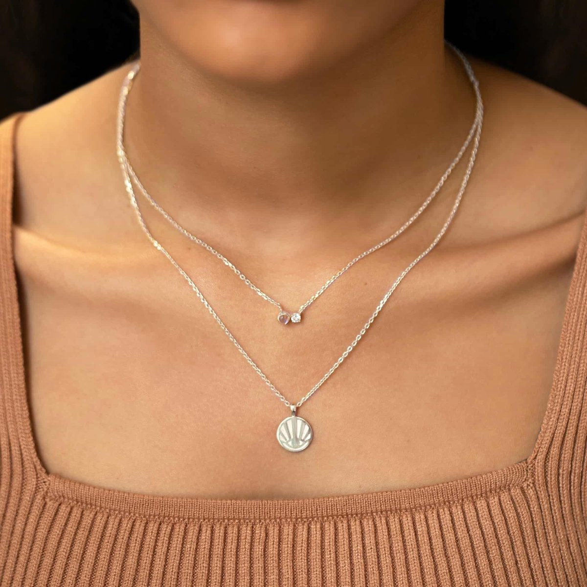 Sterling silver moonstone and clear-stone duet necklace, shown layered on a model's neckline
