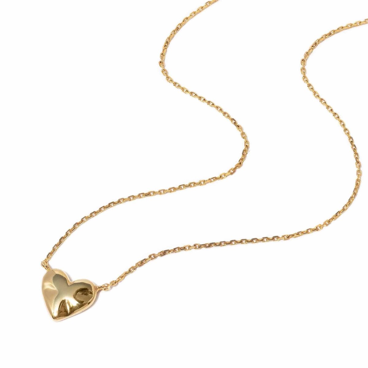 Gold vermeil puffed heart pendant necklace on a fine cable chain, laid on a white background