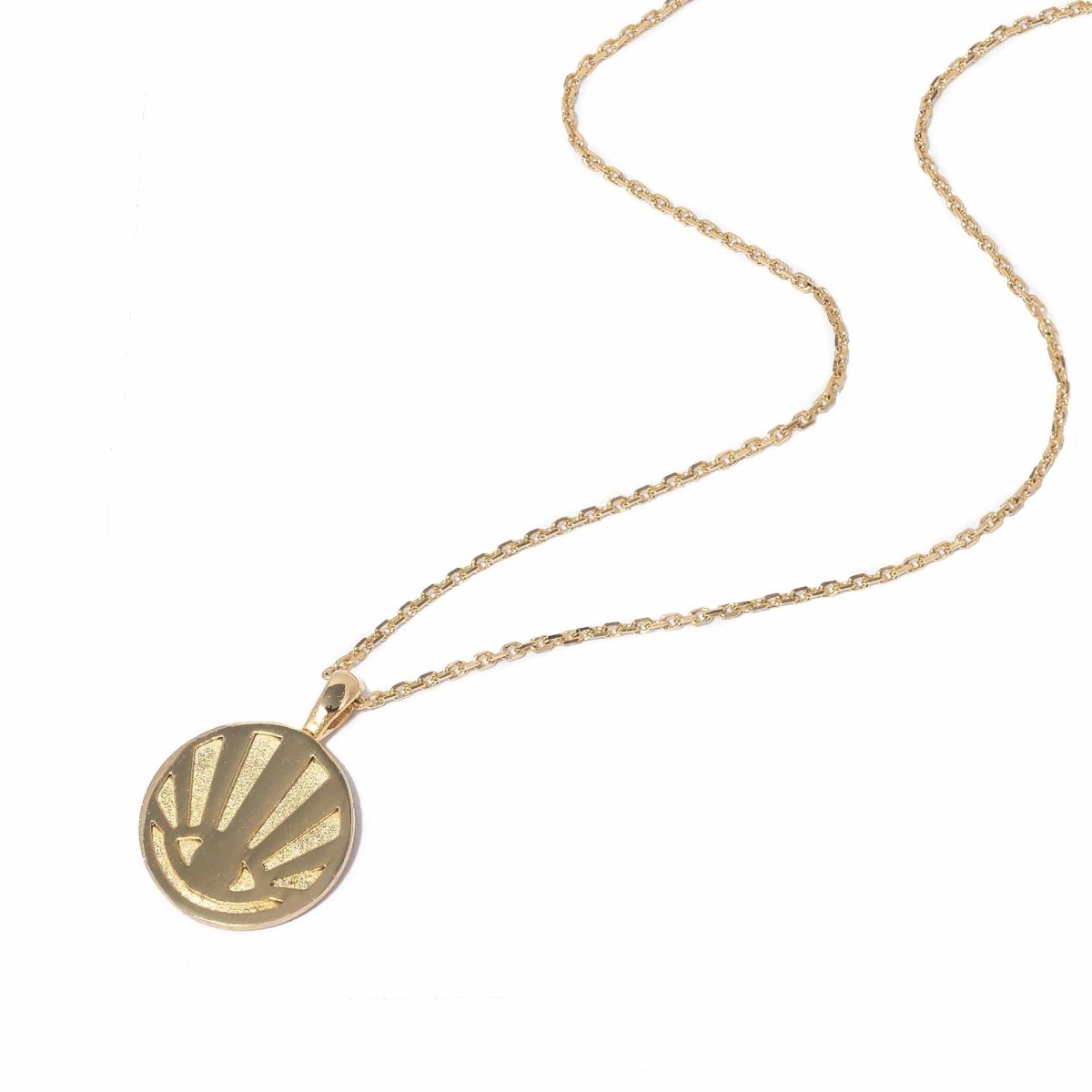 Gold vermeil round sunburst rays pendant necklace on a chain, on a white background