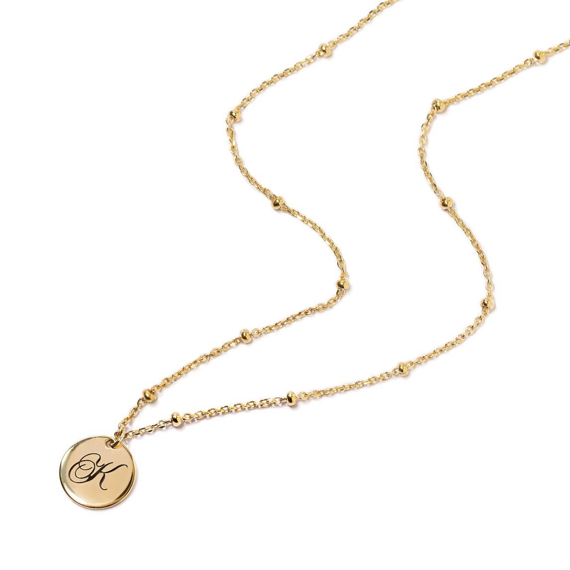 Gold vermeil initial disc on a beaded chain necklace, engraved with an initial, on a white background