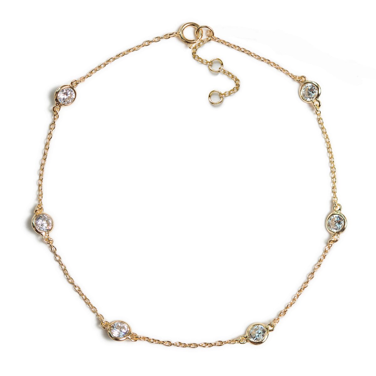 Gold vermeil station anklet with five round bezel-set clear stones, on a white background