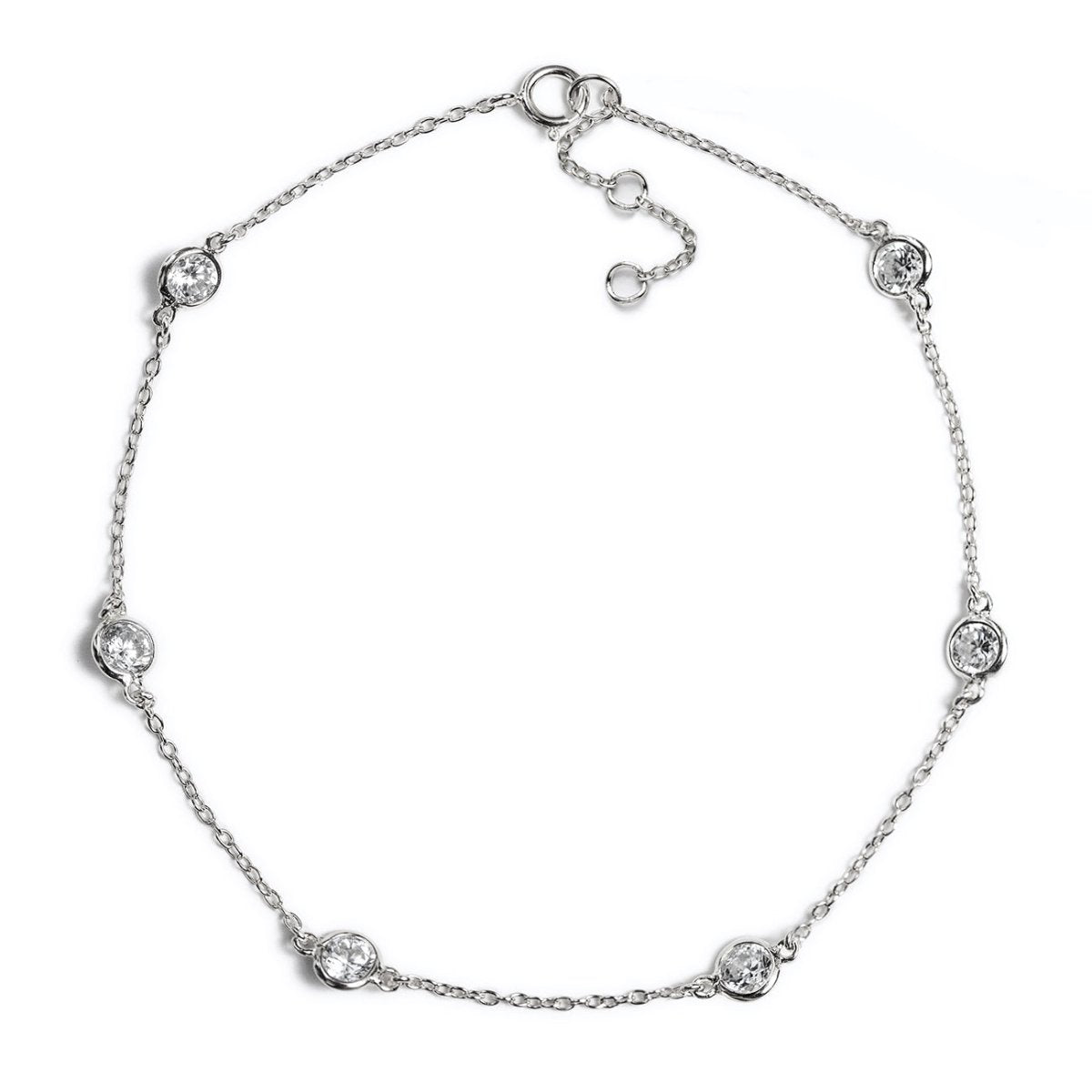 Sterling silver station anklet with five round bezel-set clear stones, on a white background