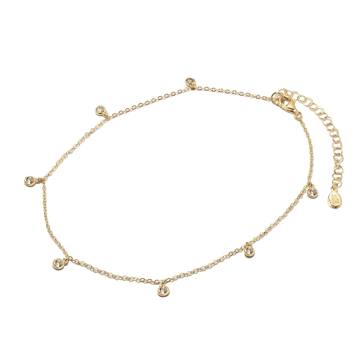 Gold vermeil tiny station anklet with small bezel-set clear stone drops and a lobster clasp, on a white background