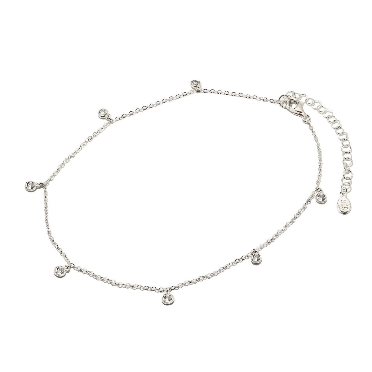Sterling silver tiny station anklet with small bezel-set clear stone drops and a lobster clasp, on a white background