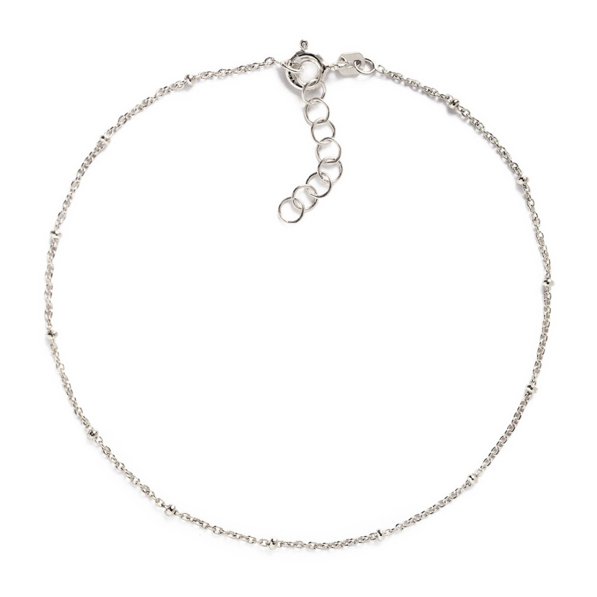Sterling silver beaded chain anklet with a spring-ring clasp and extender, laid on a white background