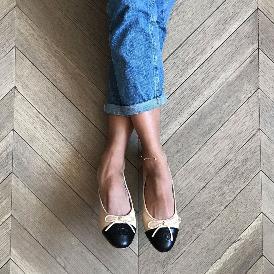 Gold vermeil clover anklet with clear stones, shown on a model's ankle with two-tone ballet flats