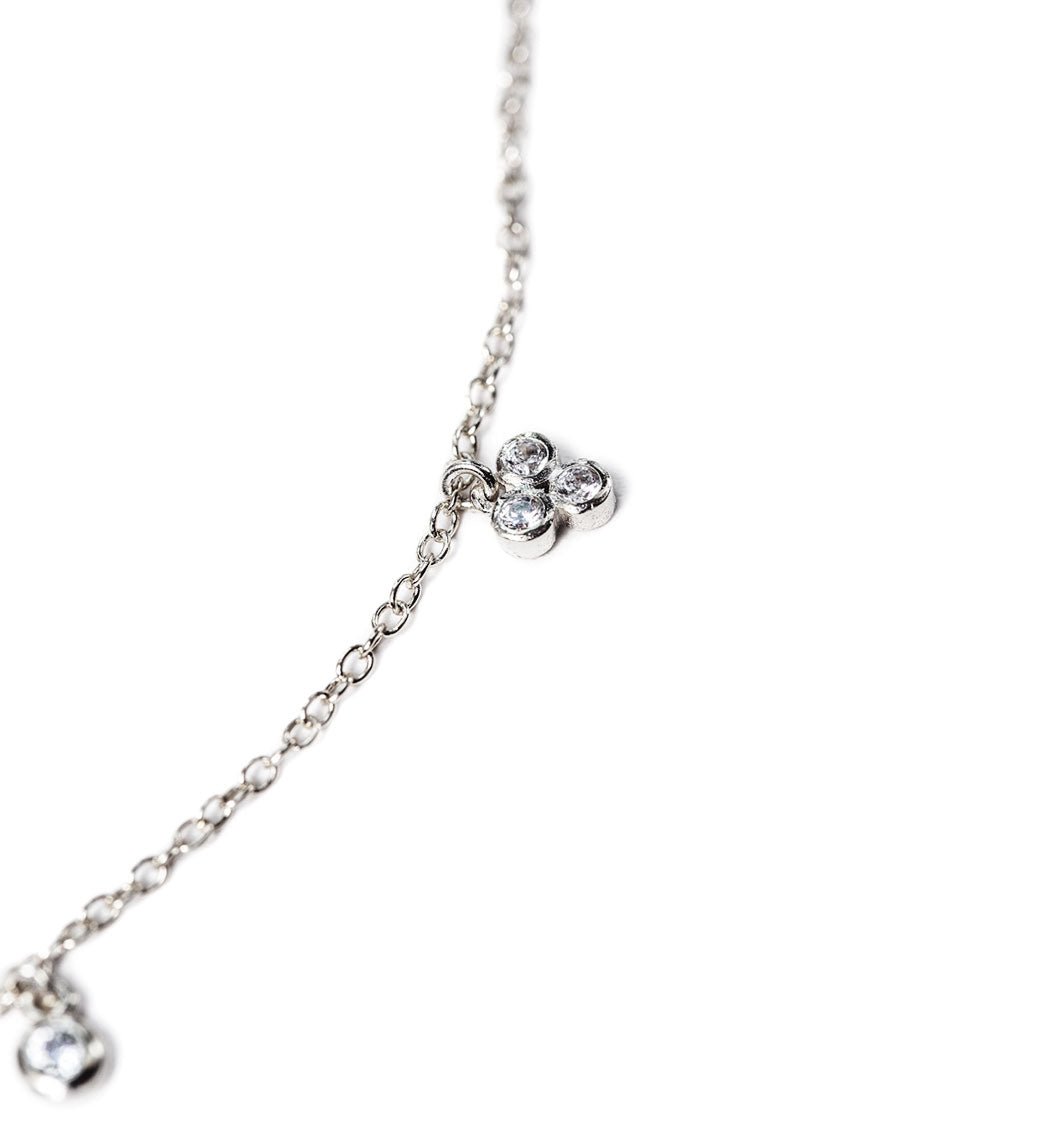 Close-up detail of the sterling silver clover crystal anklet's clustered clear stones