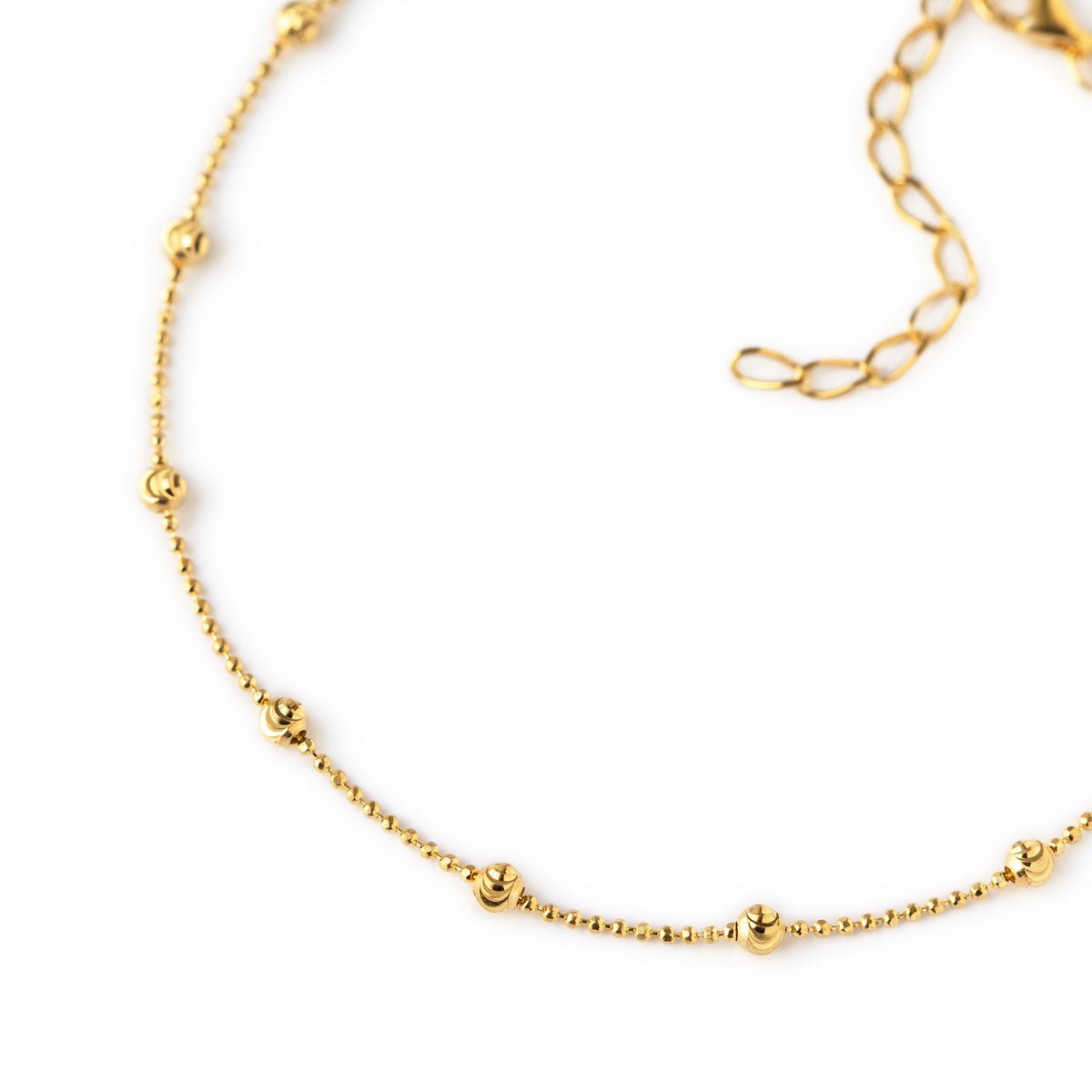 Gold vermeil faceted beaded anklet close-up showing beaded stations and chain extender, on a white background