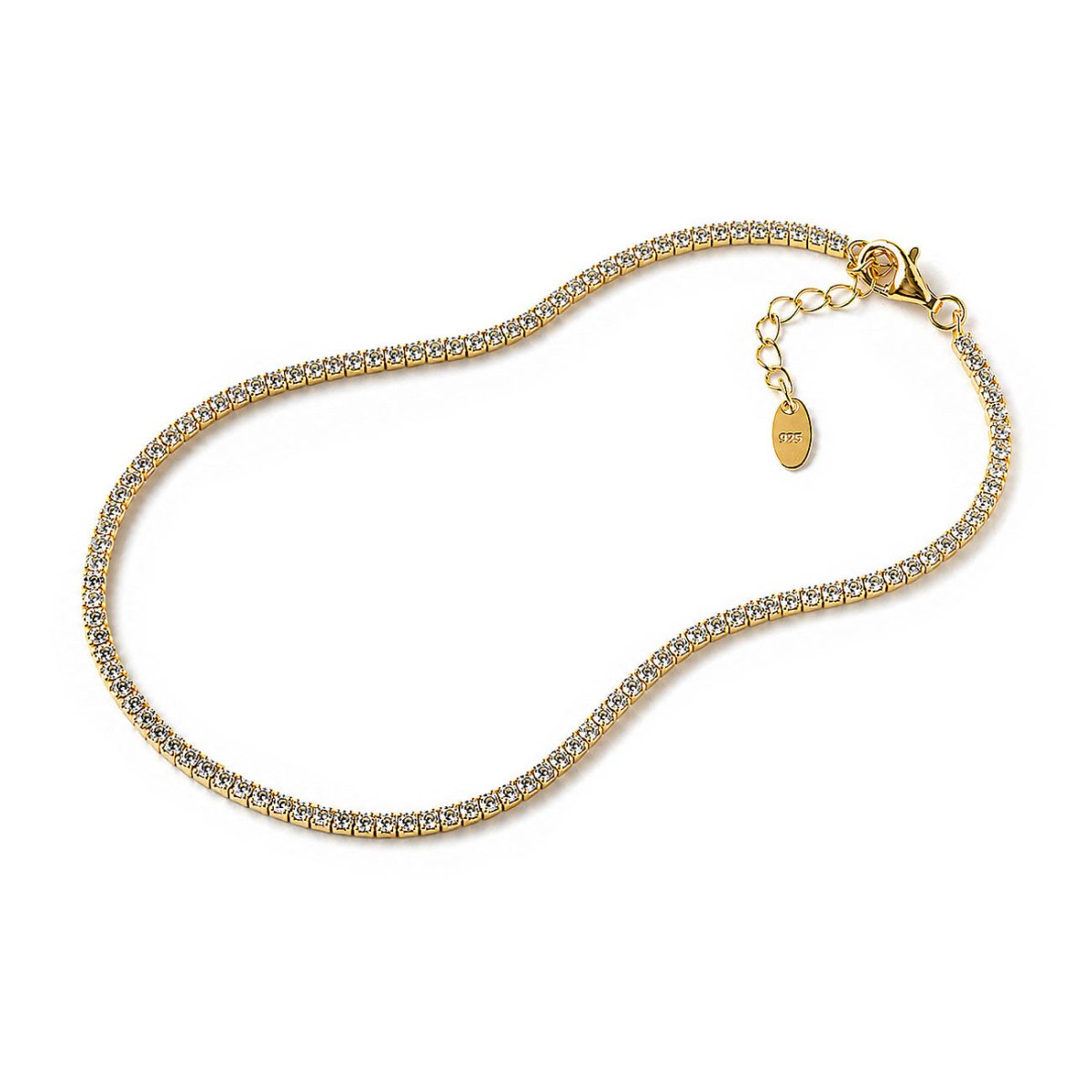 Gold vermeil tennis anklet lined with small round crystals, lobster clasp and oval tag, on a plain white background