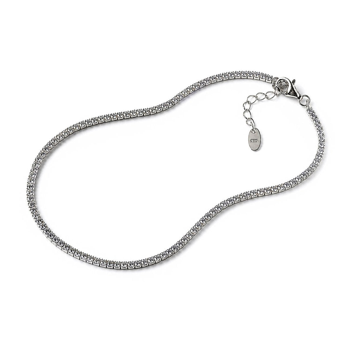 Dainty silver tennis-style anklet set with a line of small round crystals, lobster clasp and tag, laid flat