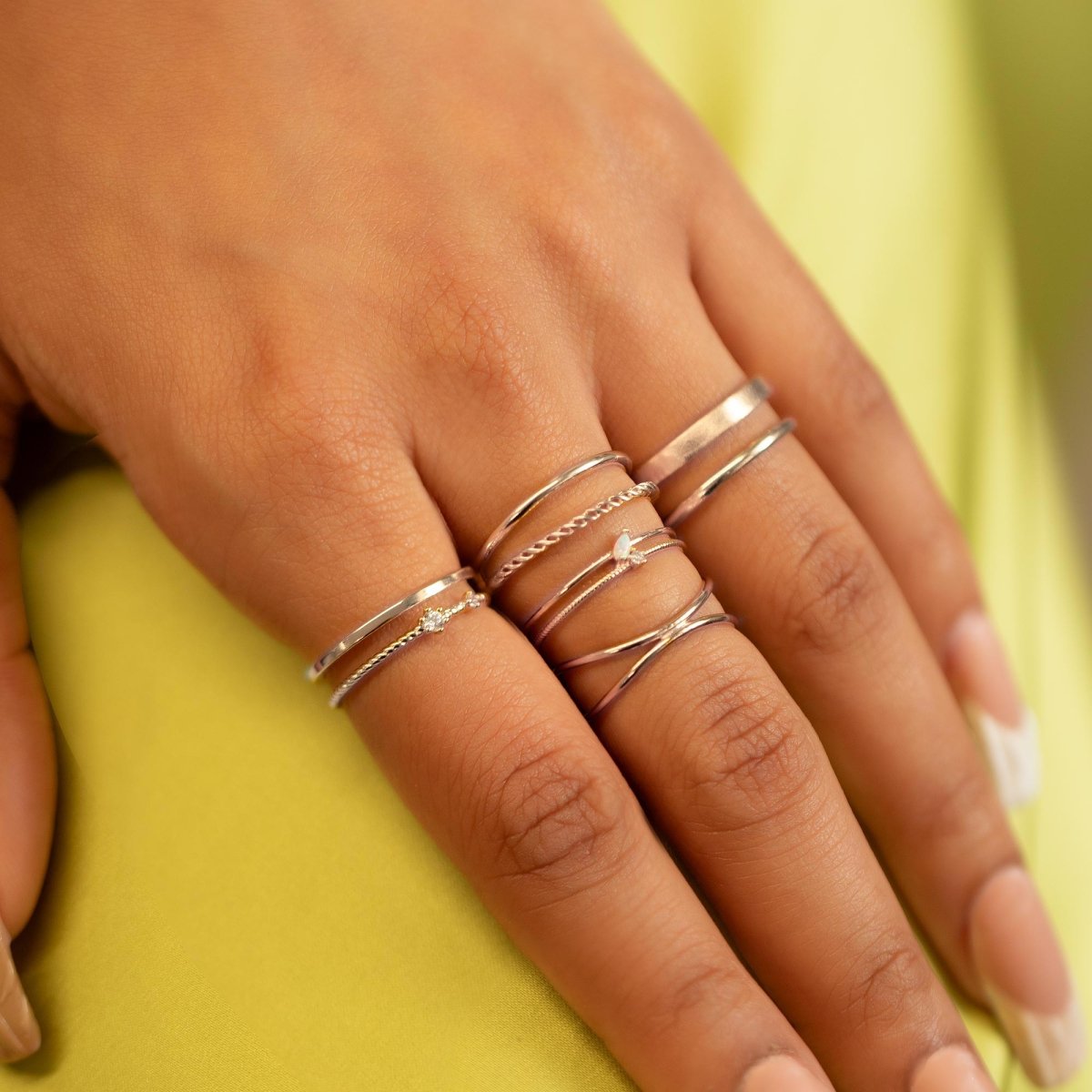 Sterling silver double band ring shown stacked on a model's fingers
