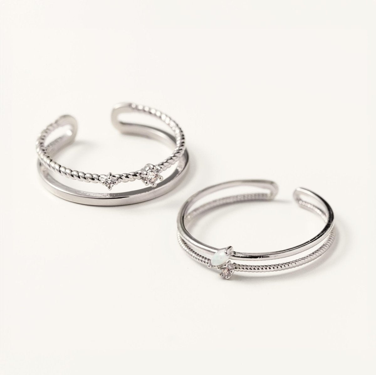 Two sterling silver rope stacking rings with white zirconia stones, shown on a white background