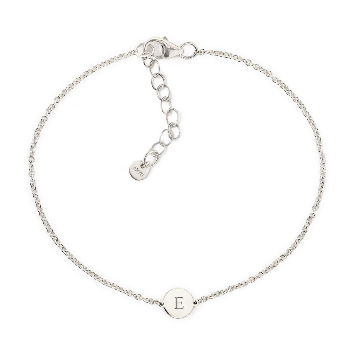 Sterling silver thin chain bracelet with a small disc engraved with an initial, on a white background