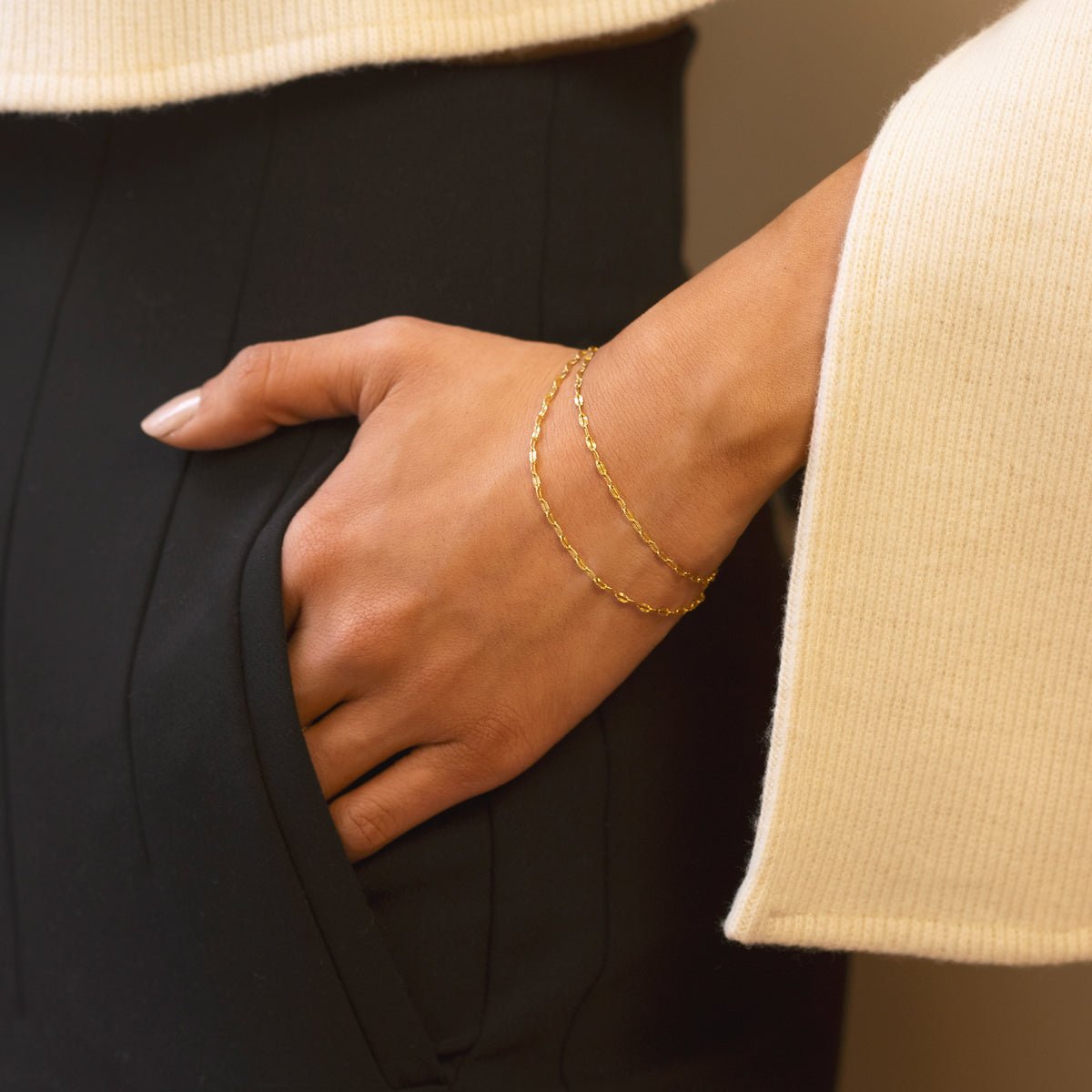 Gold vermeil lace chain wrap bracelet double-wrapped on a model's wrist