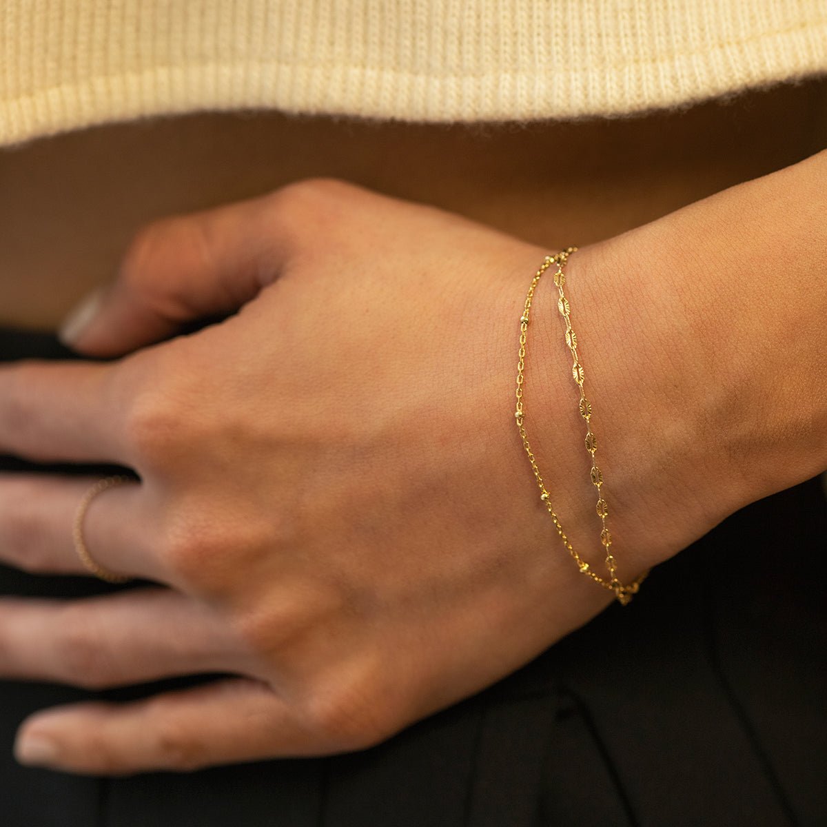 Gold vermeil double layered chain bracelet shown on a model's wrist in profile
