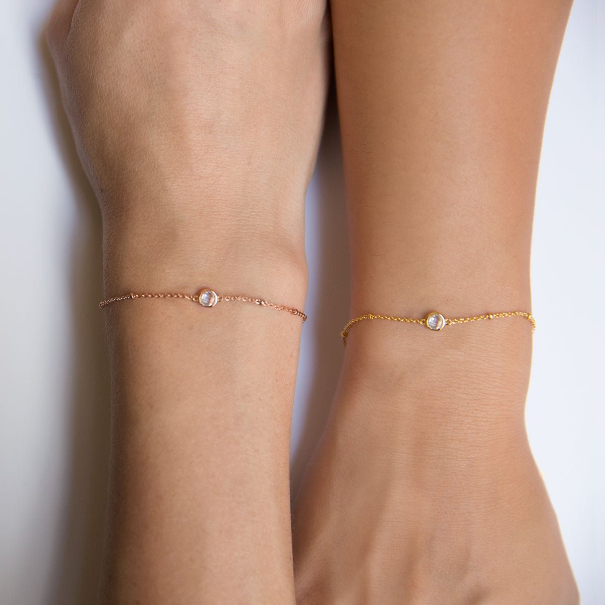 Rose gold vermeil and gold crystal chain bracelets shown side by side on two wrists