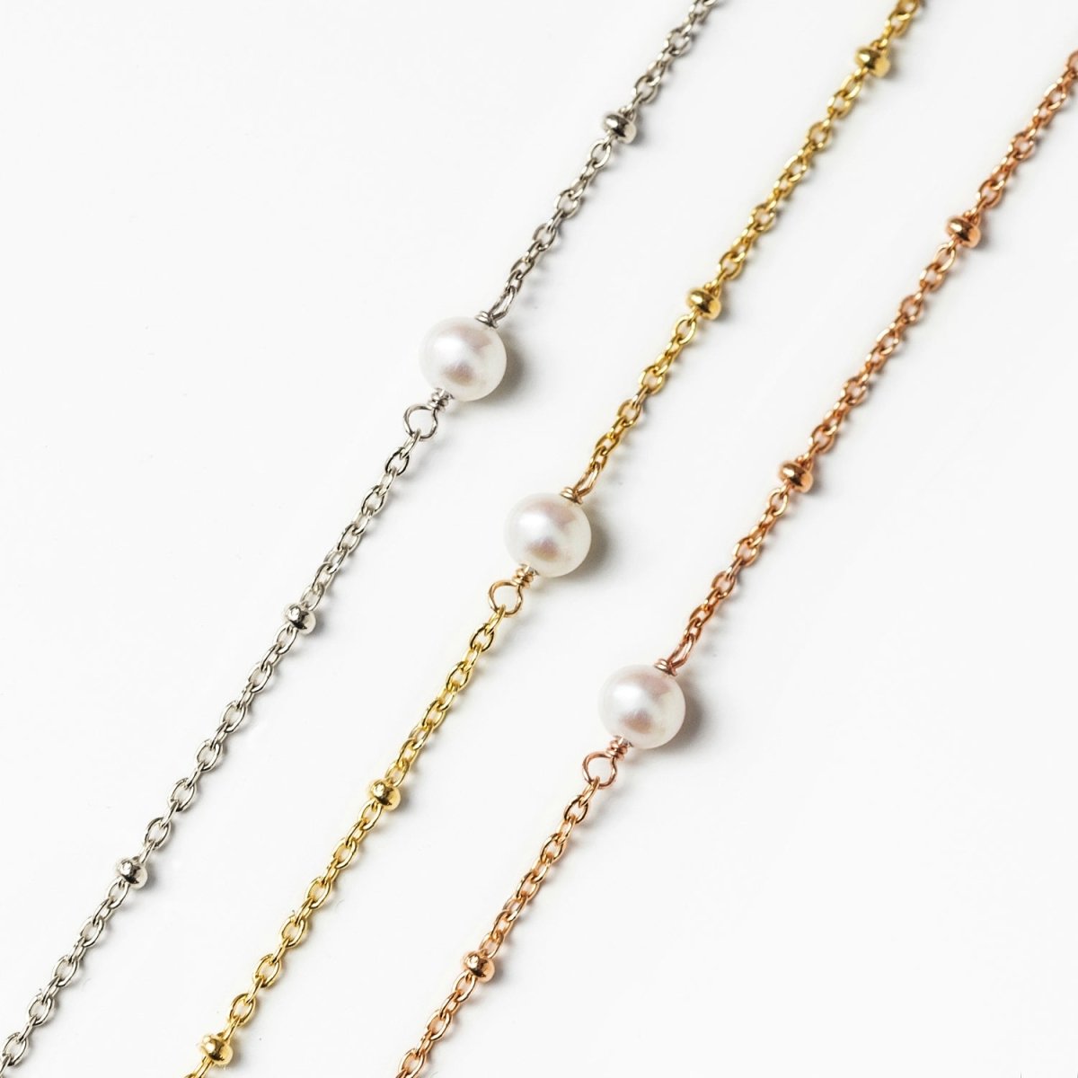 Gold vermeil pearl beaded chain bracelet shown beside silver and rose-tone versions, detail