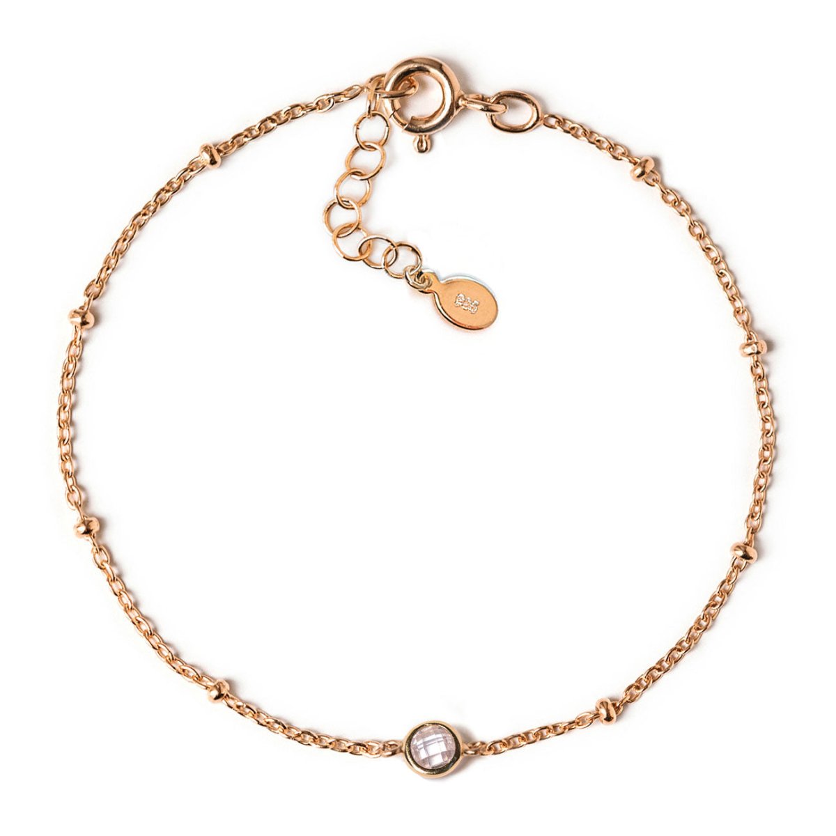 Rose gold vermeil satellite chain bracelet with a round clear stone, laid on a white background