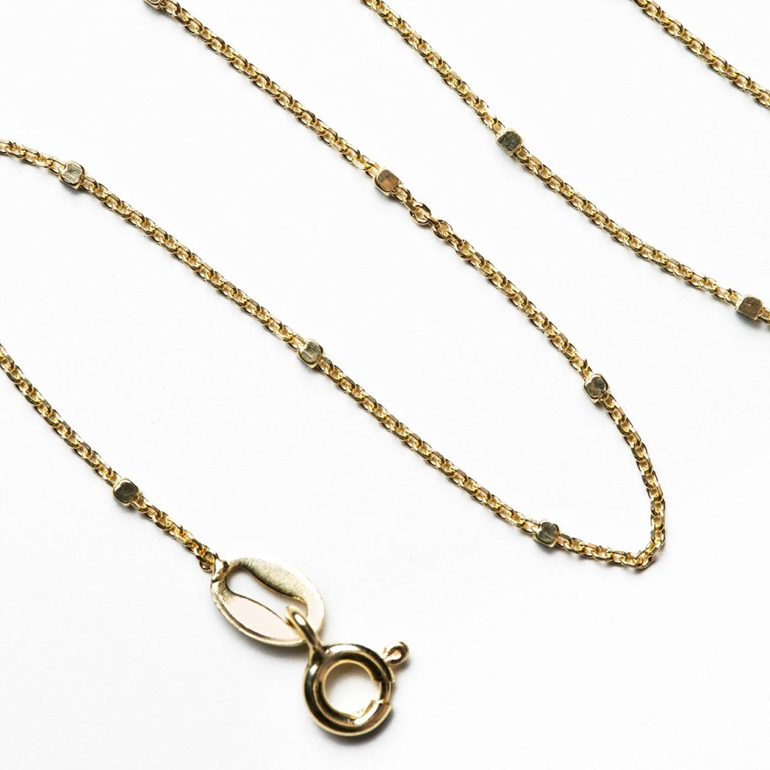 Gold vermeil dainty satellite bead chain with spring-ring clasp, close-up detail on a white background