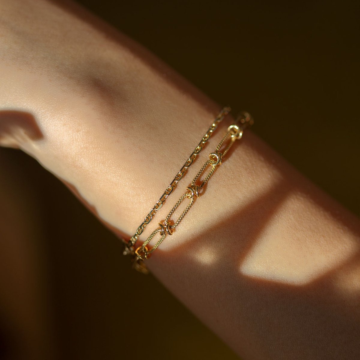 Gold vermeil chain link bracelet stacked with a thinner chain, shown on a wrist