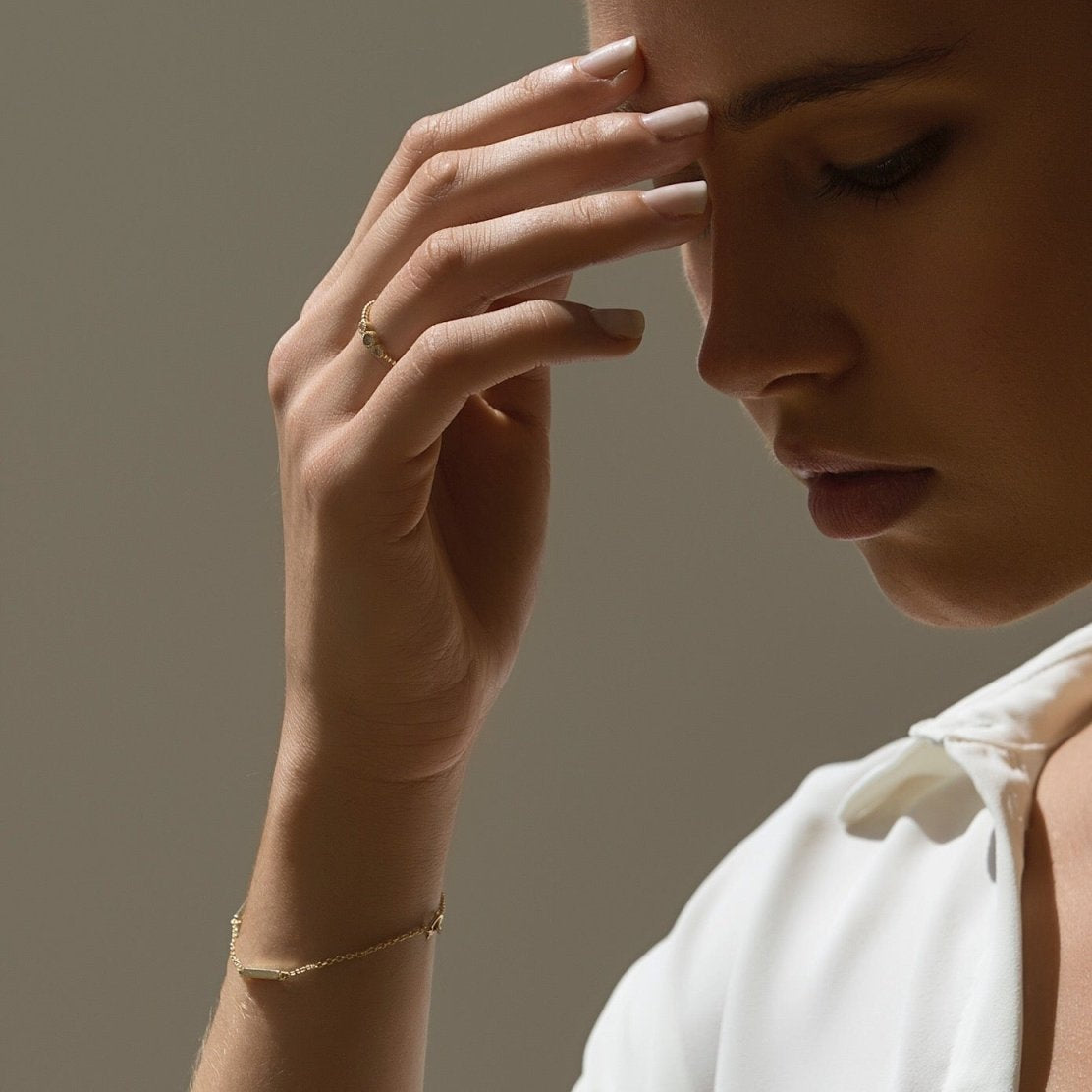 Sterling silver eternity bar bracelet on a thin chain, shown on a model's wrist