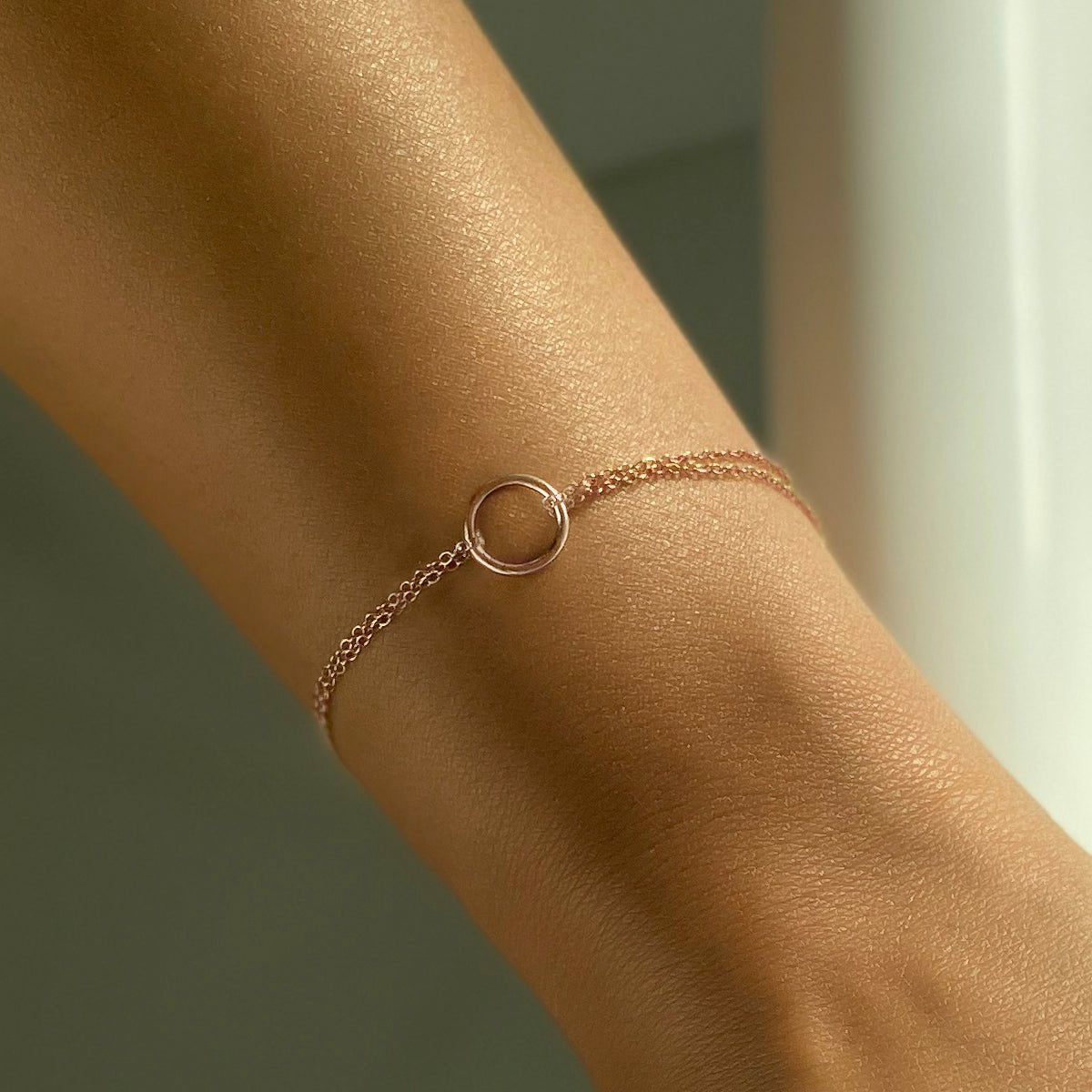 Rose gold vermeil eternity circle bracelet with an open ring on a double chain, shown on a wrist