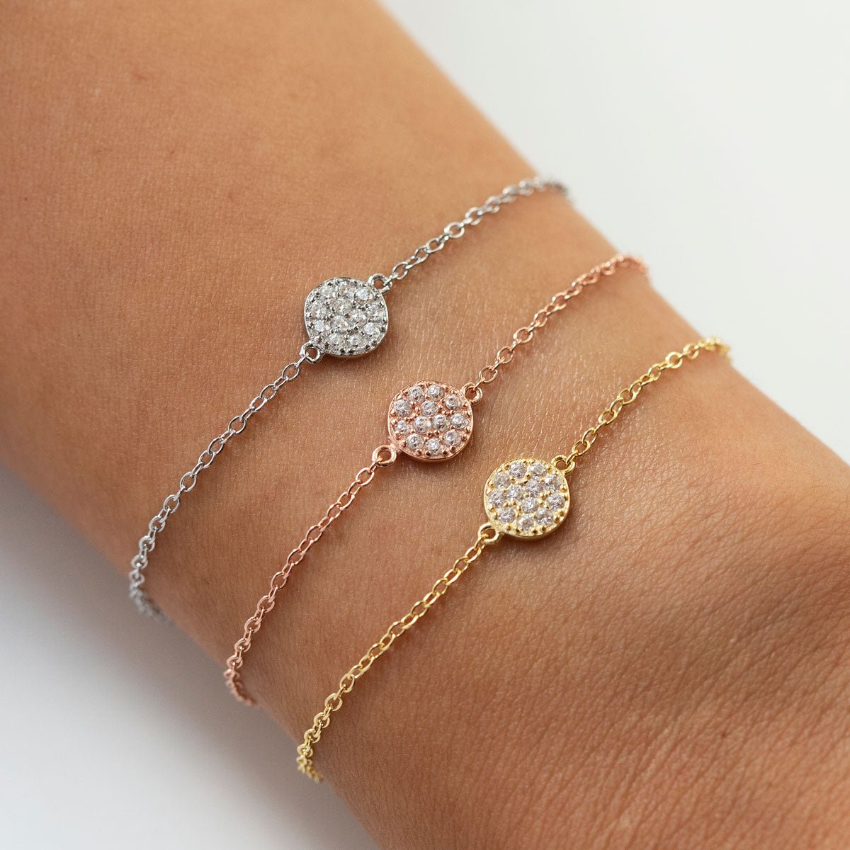 Rose gold vermeil pavé disc chain bracelet with white zirconia, shown stacked on a wrist