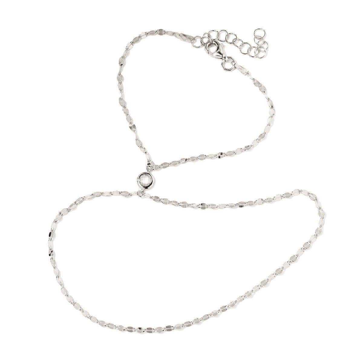 Sterling silver hand chain with a flat link chain and round white zirconia, on a white background
