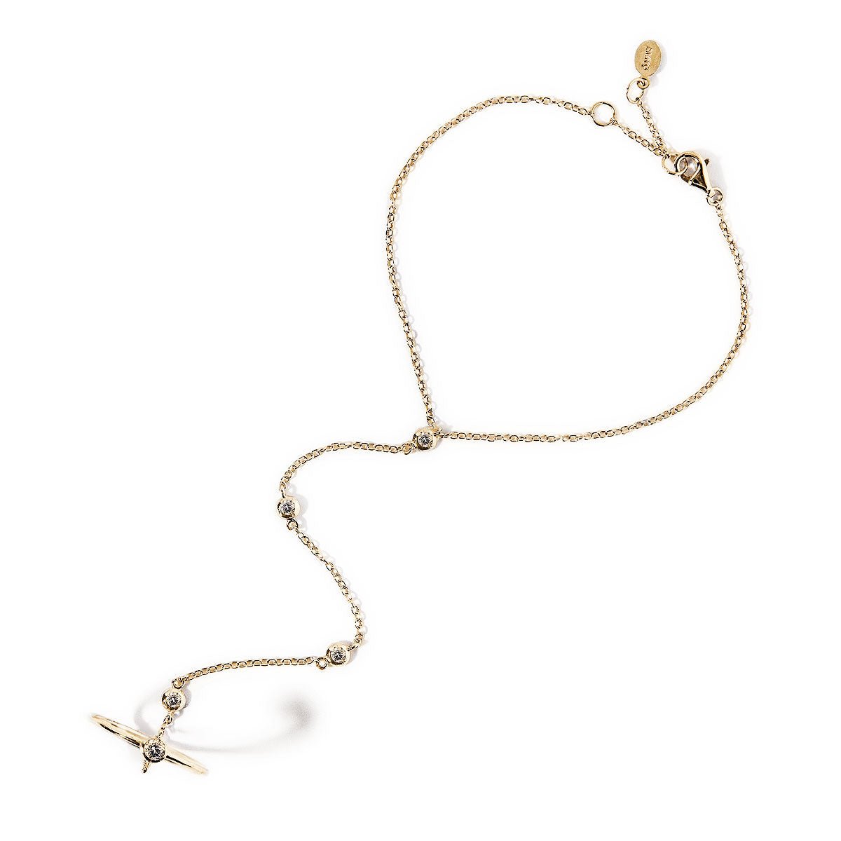 Gold vermeil hand chain with bezel-set clear stones and a cross ring, on a white background