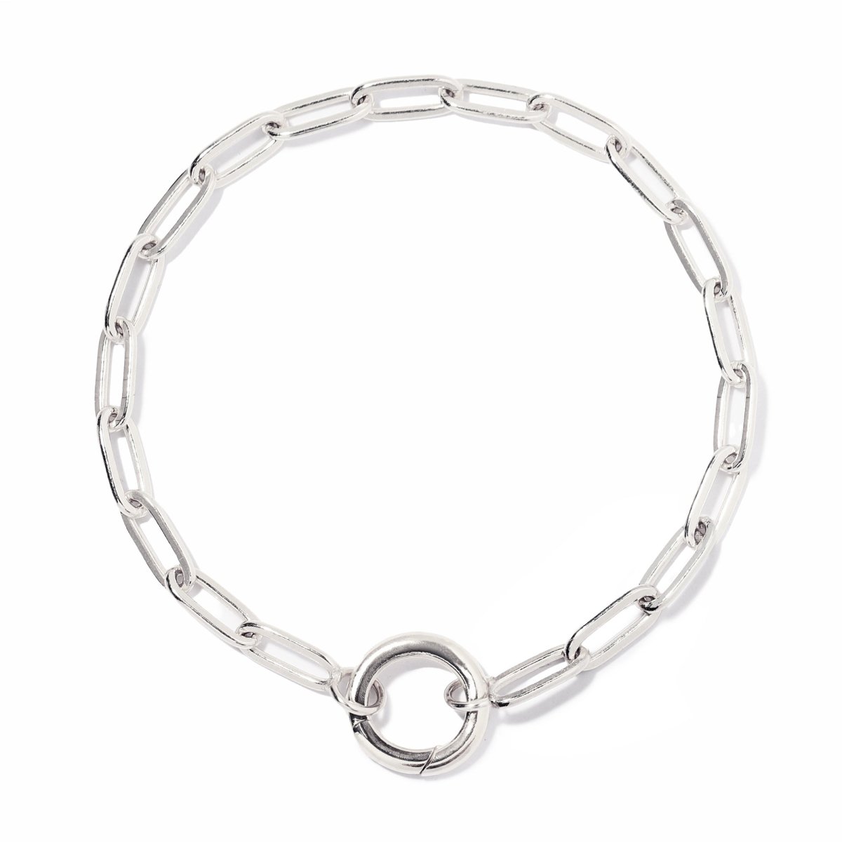 Sterling silver paperclip chain charm bracelet with a clasp ring beside loose charms, on a white background