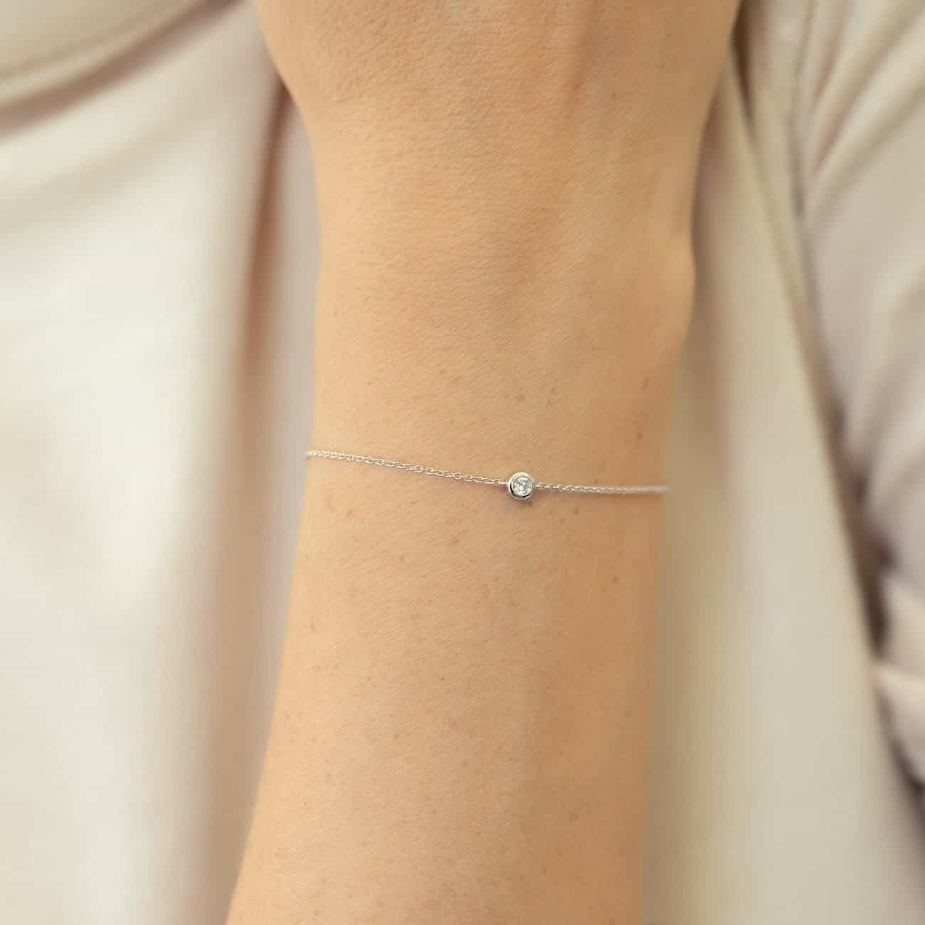 14K white gold bezel diamond chain bracelet shown on a model's wrist