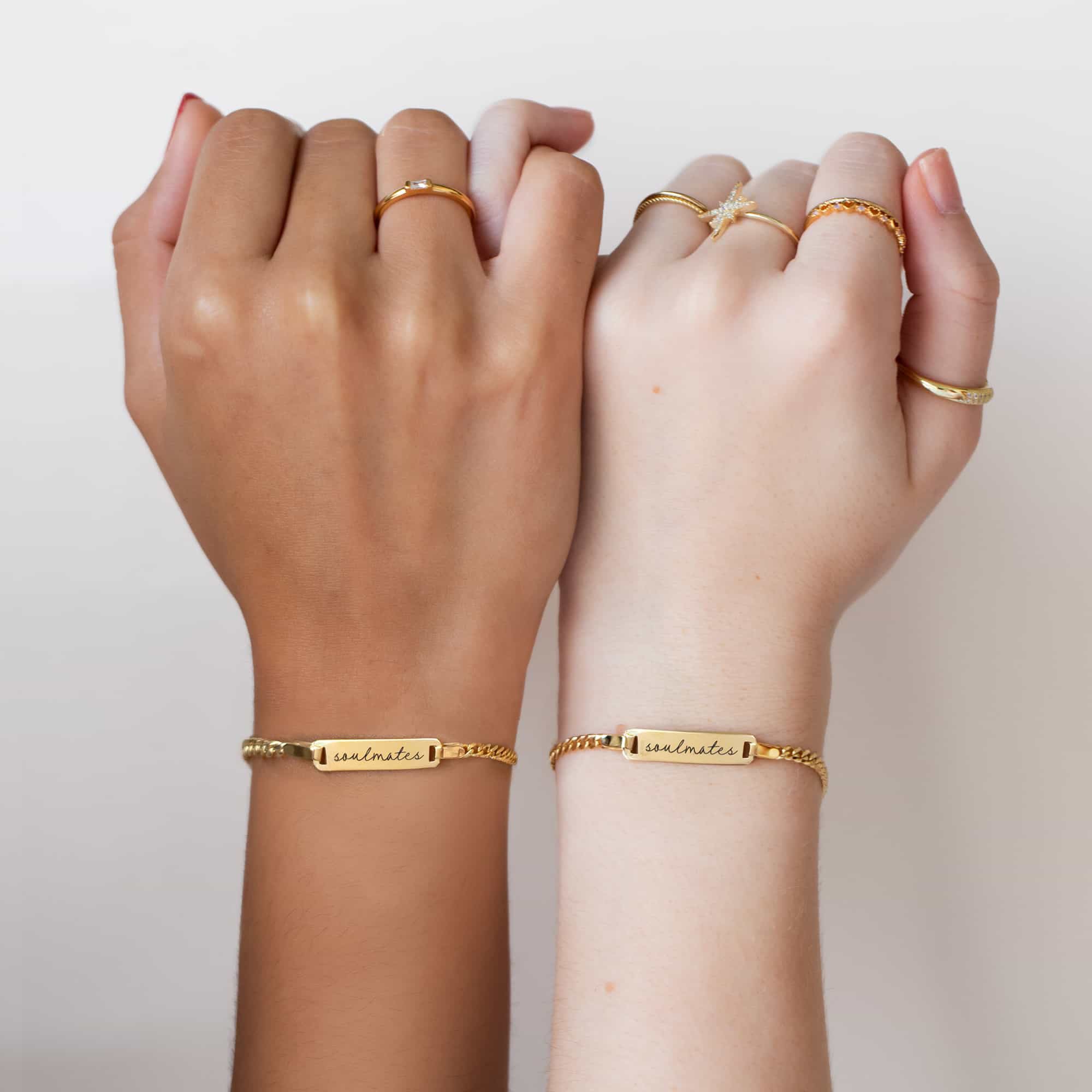 Gold vermeil ID bracelets engraved with a name, shown on two models' wrists side by side