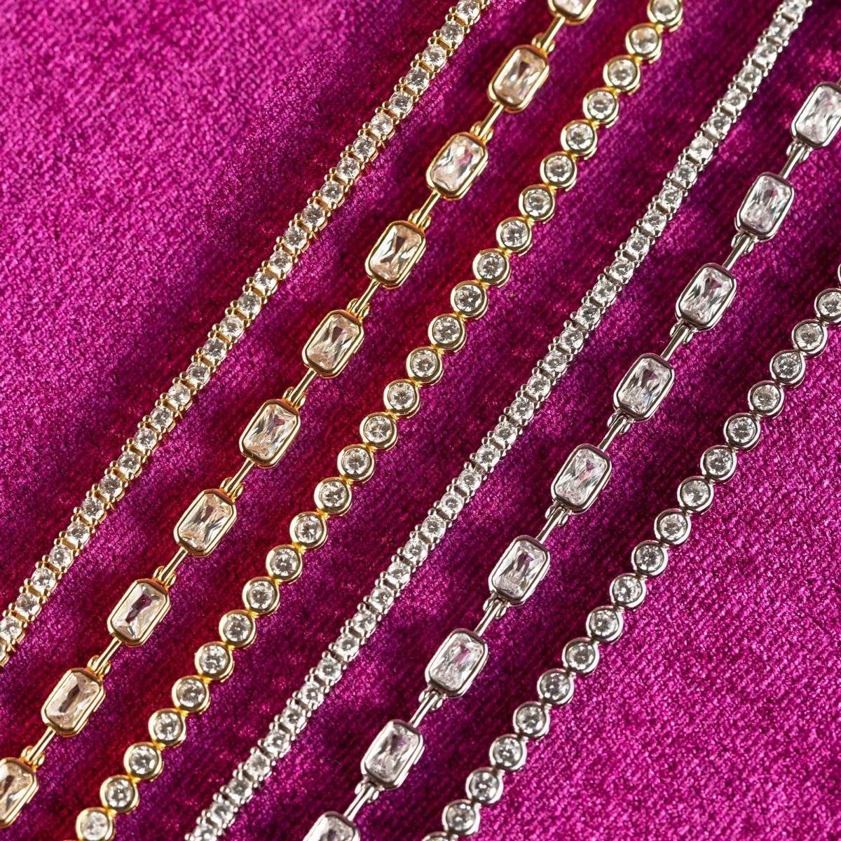 Sterling silver and gold crystal tennis bracelets with white zirconia stones, on pink velvet