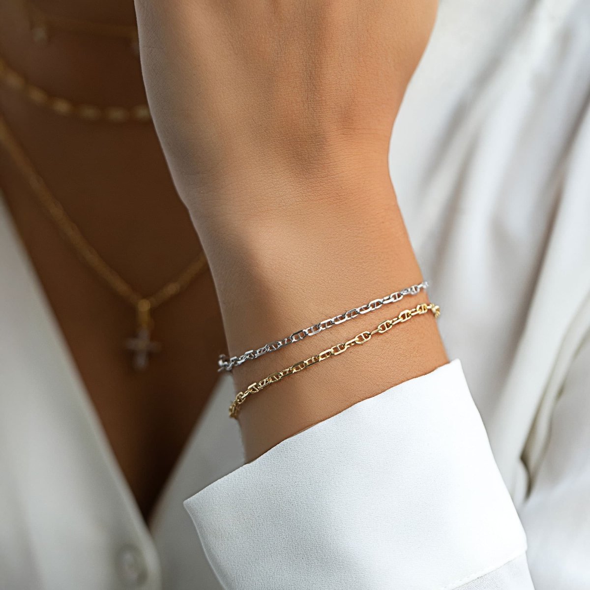 Gold vermeil Marina chain bracelet layered with a paperclip chain, shown on a model's wrist