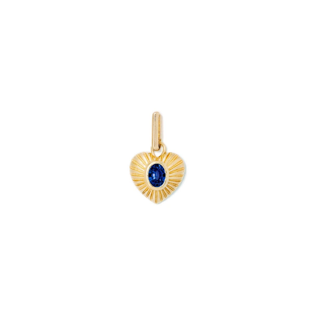Gold vermeil ridged heart charm with an oval blue sapphire center, on a white background