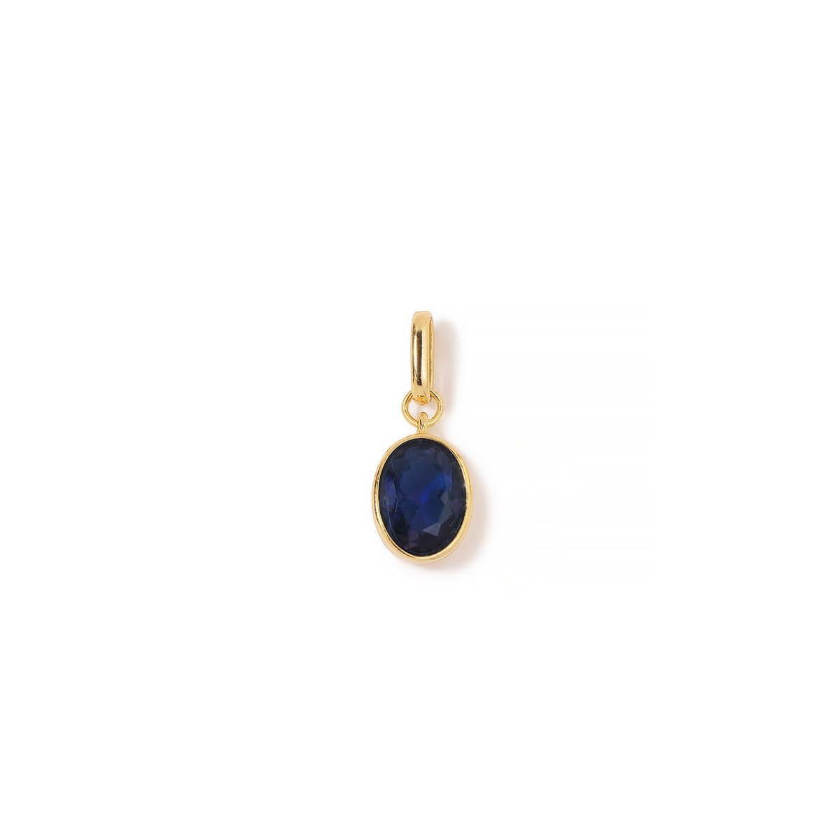 Gold vermeil oval charm with a bezel-set blue sapphire stone, on a white background