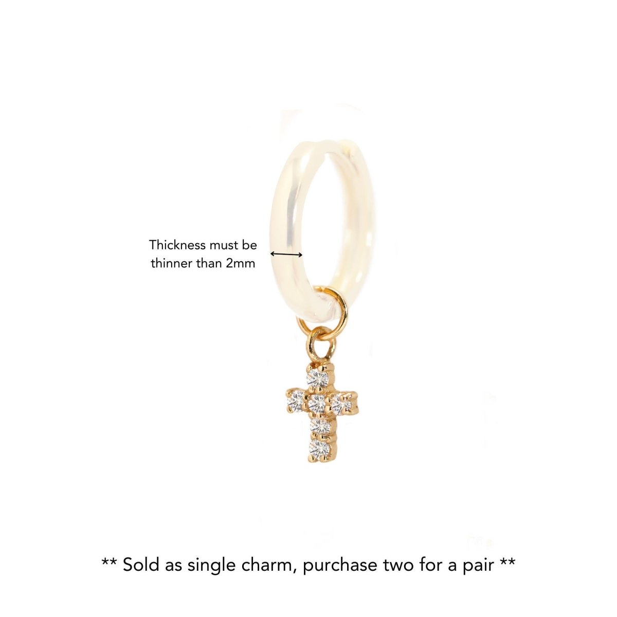 14K gold huggie hoop with a dangling clear-crystal cross charm, on a white background; sold as single