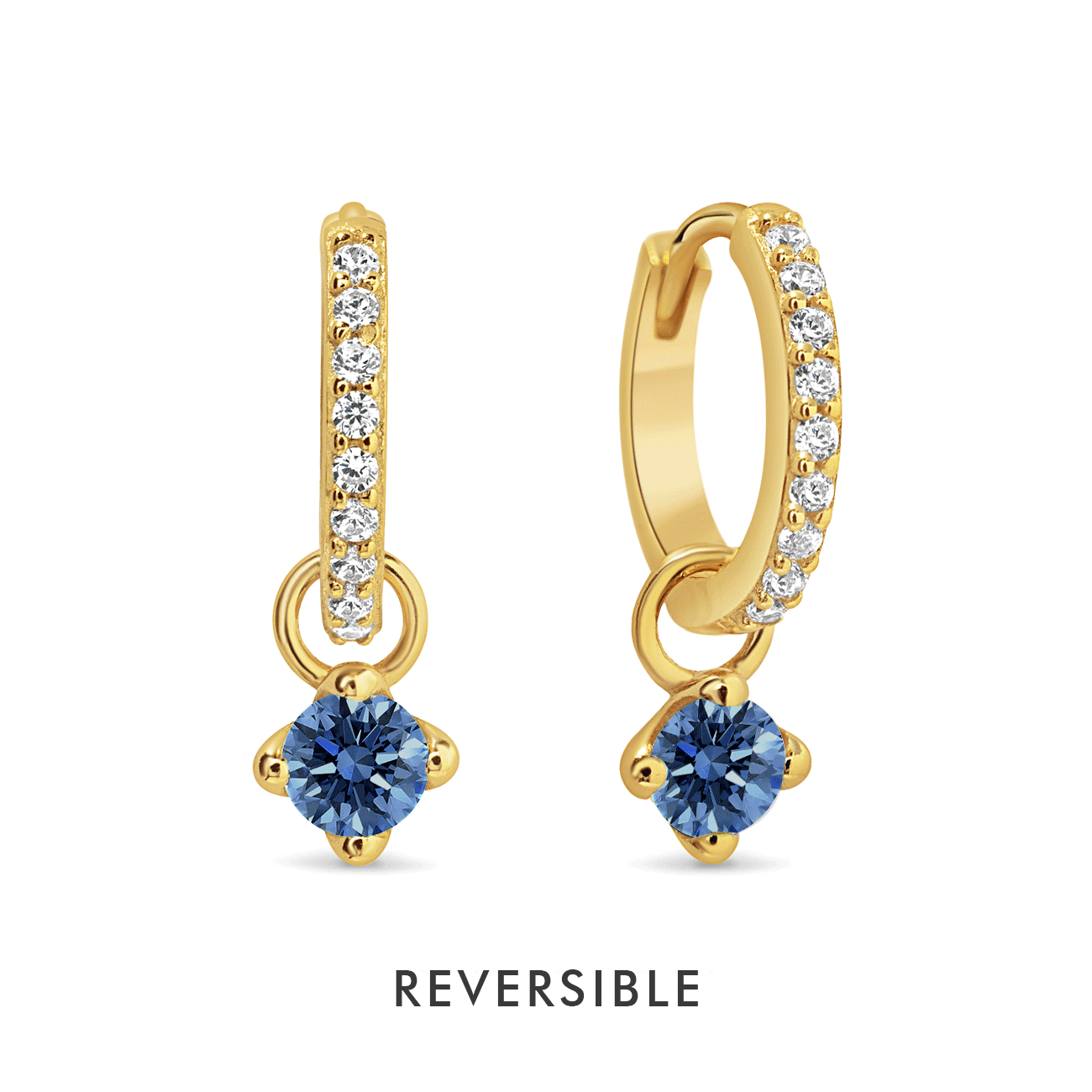 Gold vermeil pavé huggie hoops with a dangling round blue sapphire charm, on a white background