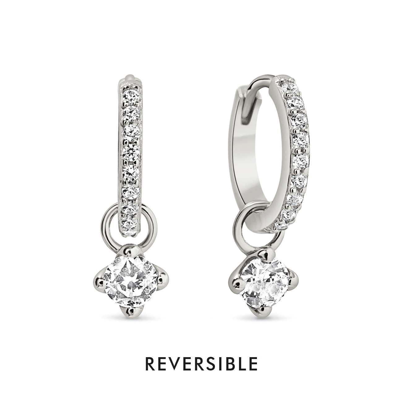 Sterling silver pavé huggie hoops with dangling white zirconia charms, on a white background