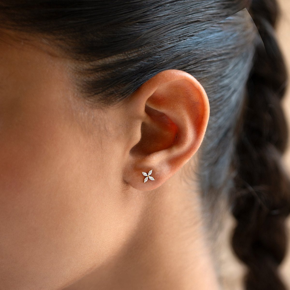 Gold titanium crystal fleur flat back stud earrings, shown on a model