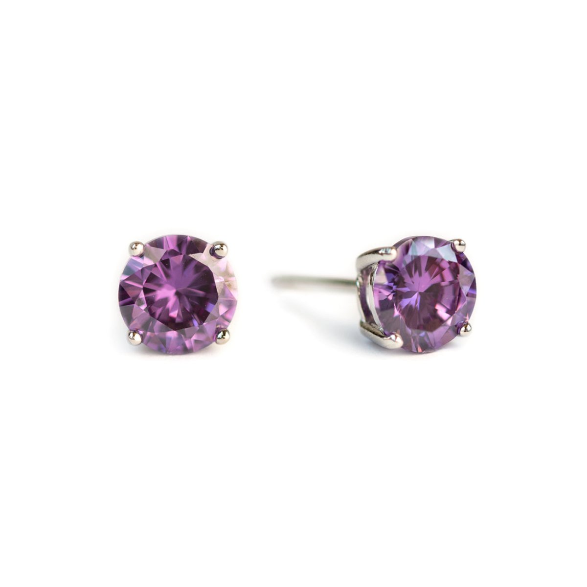 Pair of sterling silver amethyst studs with round purple stones, on a white background