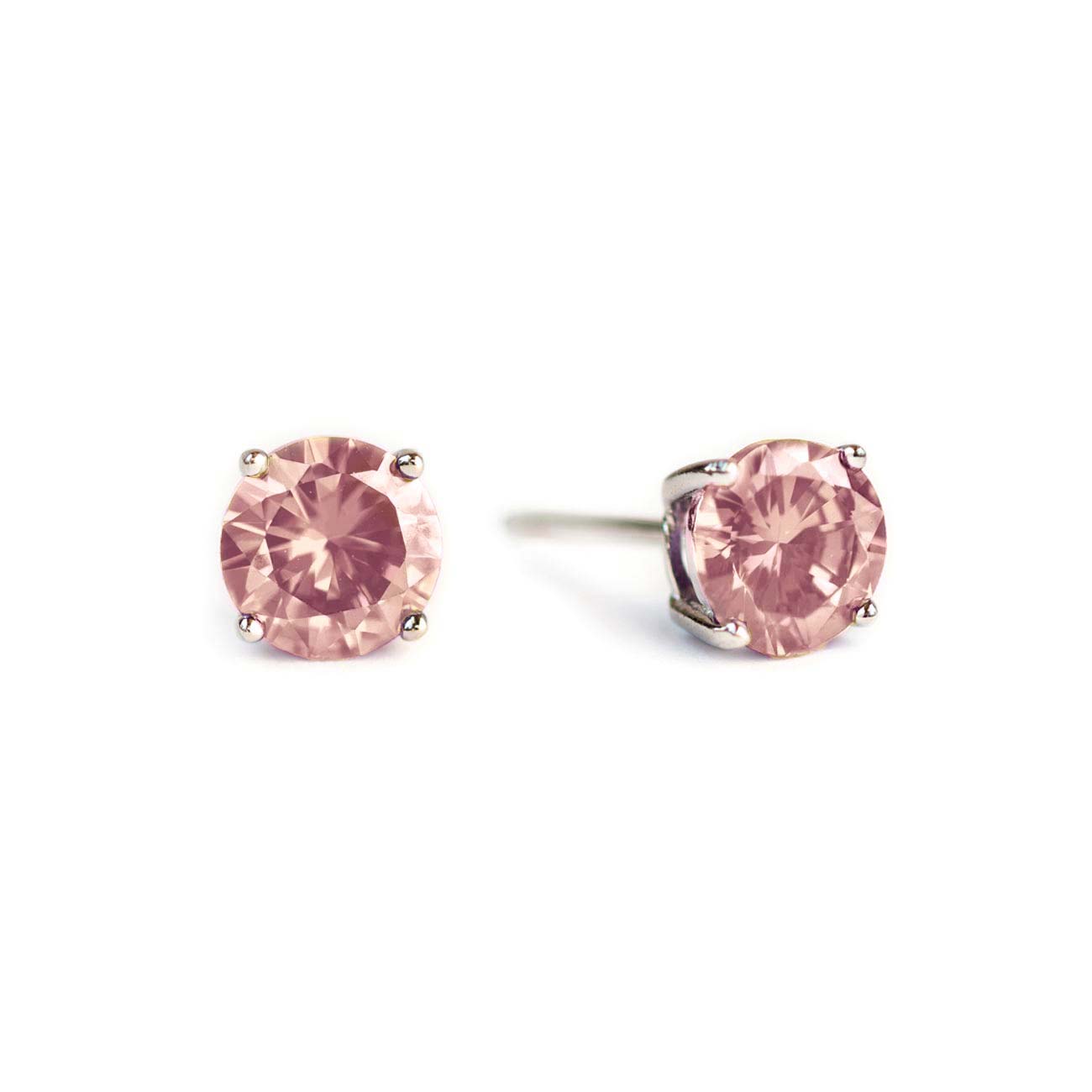 Sterling silver pink sapphire studs with round pink stones in four-prong settings, on a white background